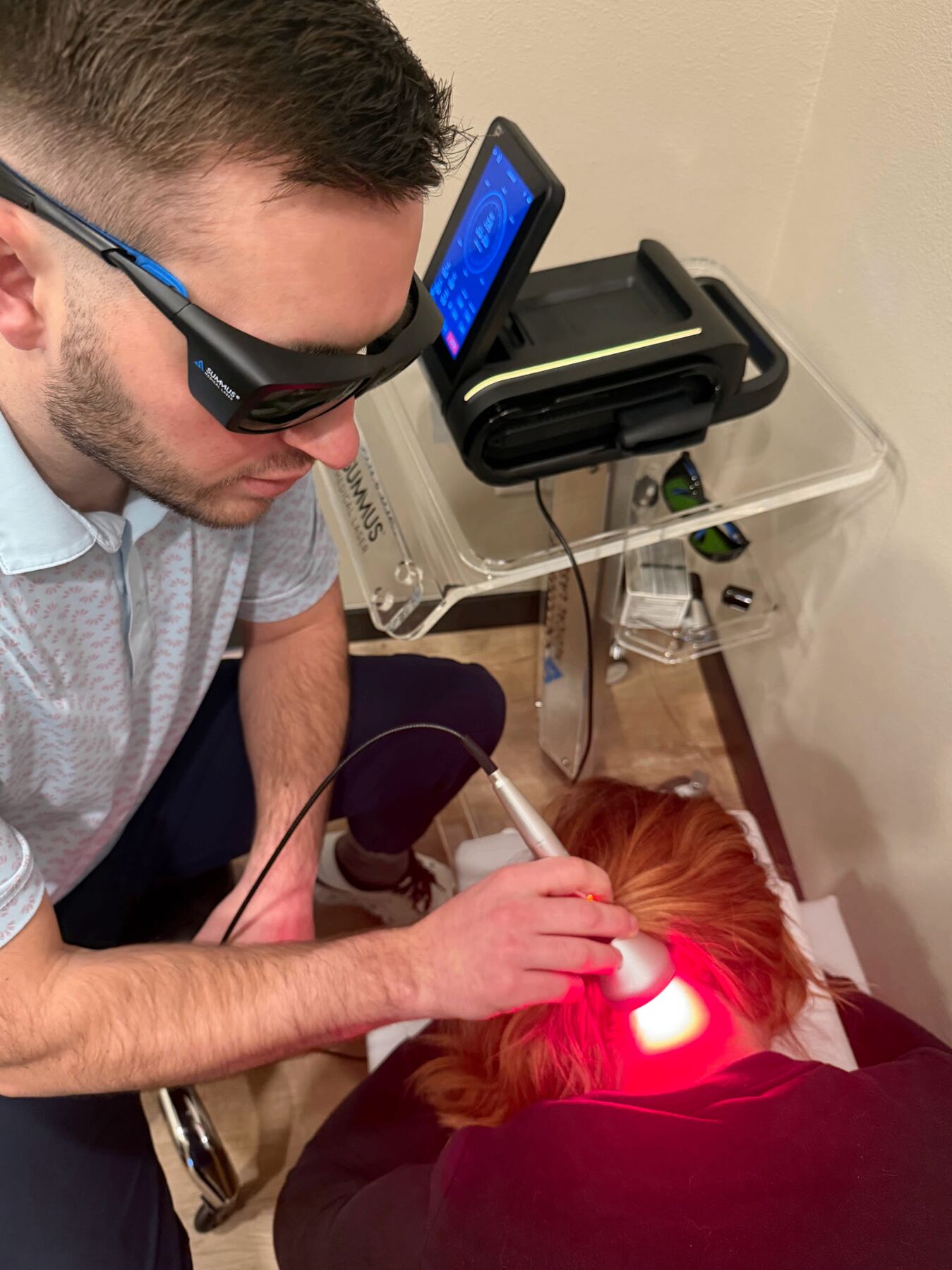 Dr. Dakota performing Class IV laser therapy on a patient at Envision Chiropractic Bellingham