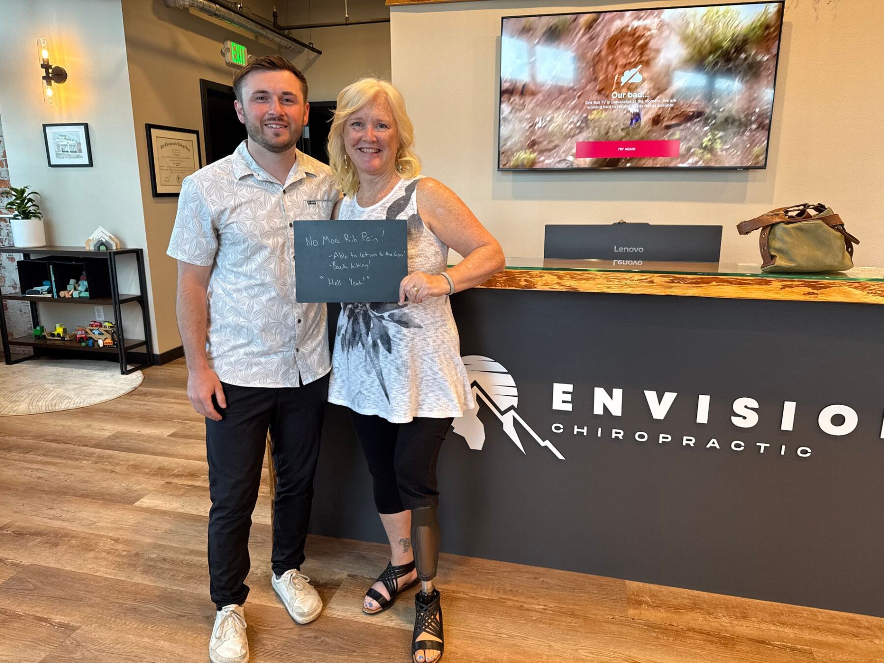 Dr. Dakota with a patient at the Envision Chiropractic reception desk