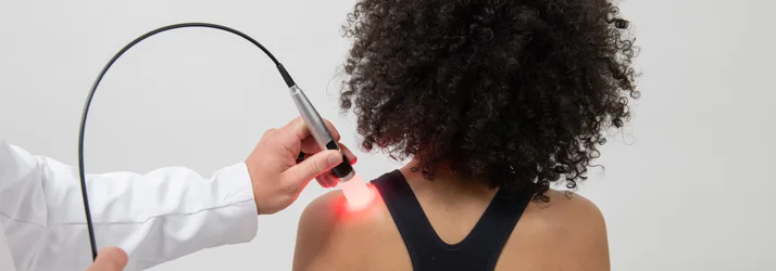 Laser therapy on a patients shoulder.